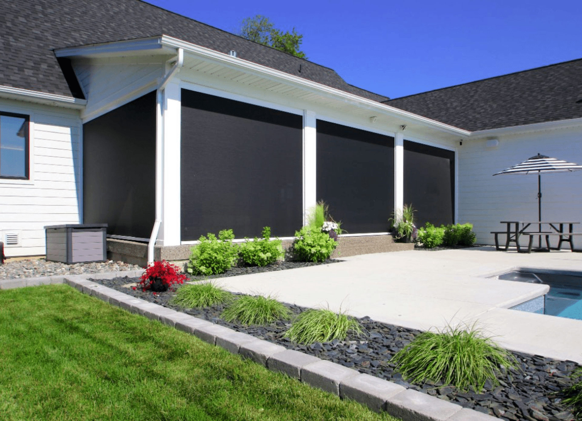 Modern patio with garden and swimming pool.